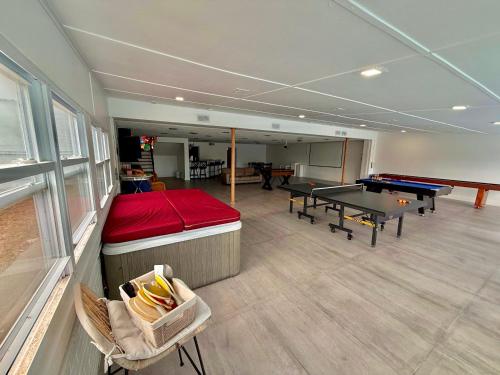 a room with a pool table and ping pong tables at Ultimate Luxury Villa - Pool, Sauna, Hot Tub & More in Paterson
