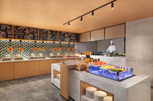 a kitchen with a chef standing in the kitchen at Fairfield by Marriott Hangzhou Gongshu in Hangzhou