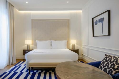 a hotel room with a bed and a table at El Autor Hotel, Madrid, Autograph Collection in Madrid