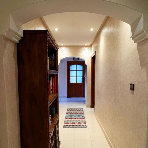 a hallway with a door and a rug on the floor at Eco Farm Tayssir Marrakech in Marrakech