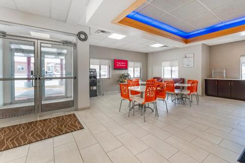 a dining room with orange chairs and a table at Red Roof Inn Johnstown in Johnstown