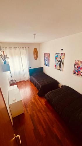 a living room with two beds and a couch at Via Sicilia in Cisterna di Latina