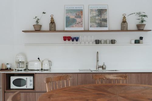 a kitchen with a counter with a sink and a microwave at Better than good in Jeju