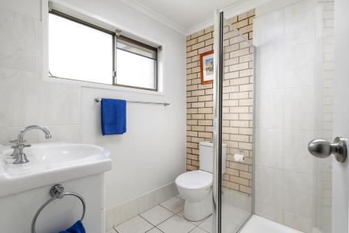a bathroom with a toilet and a sink at Goomeri Motel in Goomeri