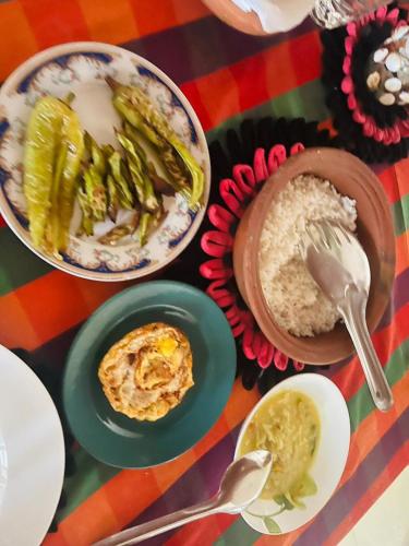 a table with plates of food and bowls of food at Vista villa in Panama