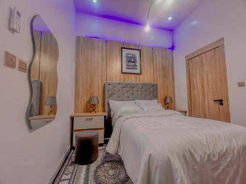 a bedroom with a bed with a purple ceiling at Westbrook Homestay LekkiLuxury 4 bedroom with 24 power,PS5&Security in Lekki