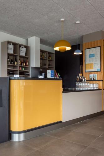 a yellow and white counter in a restaurant at Best Western Hotel Kiefersfelden in Kiefersfelden
