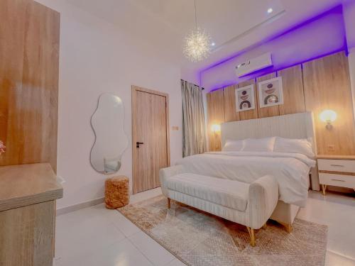 a bedroom with a large bed with a purple ceiling at Westbrook Homestay LekkiLuxury 4 bedroom with 24 power,PS5&Security in Lekki