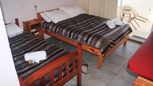 two beds sitting in a room with at Otway Junction Motor Inn in Lavers Hill