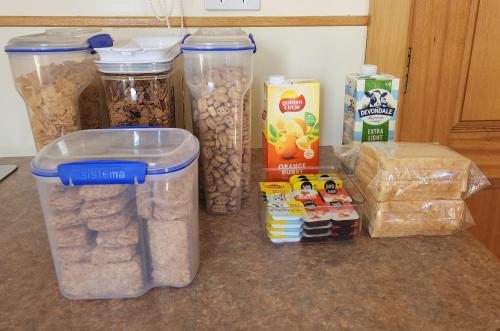 a counter with containers of peanuts and other food items at Ruby's Cottage Farm Stay in Port Arthur