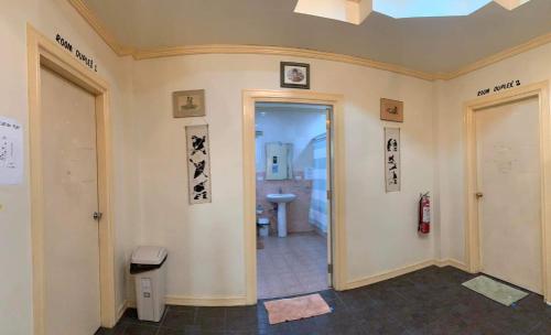 a room with a hallway with a door and a bathroom at Pundaquit Luxury Resort in San Antonio