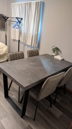 a dining room table with chairs and a lamp at 2, Nerima, 1st floor apartment, 練馬 in Tokyo