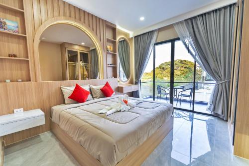 a bedroom with a large bed with red pillows at Luxury Executive 5 Bedroom Pool Villa in Jomtien - J5 in Jomtien Beach