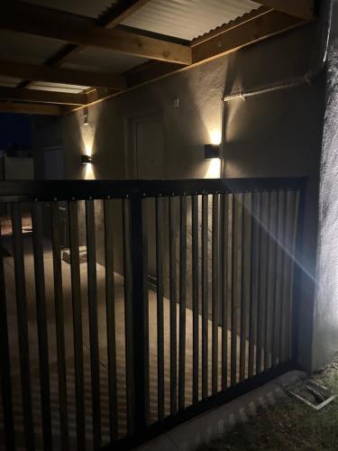 a fence in a dark room with lights on it at Hotel BEMMA in Mariscala