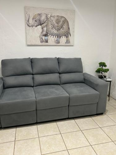 a couch in a room with a picture of an elephant at Hotel BEMMA in Mariscala