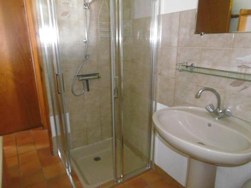 une douche avec une porte vitrée à côté d'un lavabo dans l'établissement Maison proche plage pour 8/9 pers - Animaux acceptés - FR-1-823-33, à Barbâtre