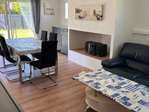 un salon avec une table et un canapé dans l'établissement Maison de charme 4/5 pers, proche plage & commerces - FR-1-823-24, à La Guérinière