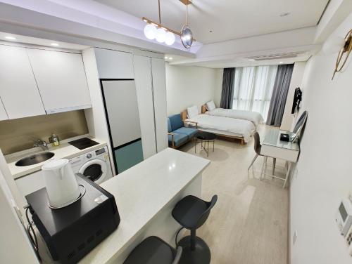 a room with a kitchen and a living room at W Residence Hotel Centum City in Busan