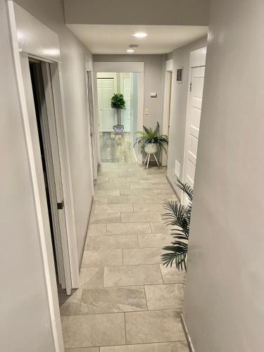 a hallway with a tile floor with potted plants at Seattle Escape Queen Anne w Private Deck in Seattle