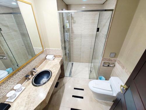 a bathroom with a sink and a toilet and a shower at W Residence Hotel Centum City in Busan
