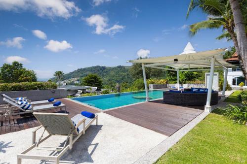 a swimming pool with a deck and a gazebo at Spectacular Ocean Views 8BR Pool Villa Sawan in Patong! Relax & Play - Billiard, Table football, Gym & Sauna! in Patong Beach