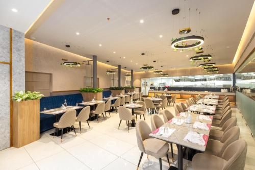 a dining room with tables and chairs at Nexstay Time Square in Kozhikode