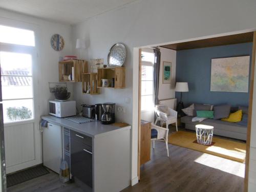 une cuisine et un salon avec un canapé dans l'établissement Maison rénovée proche plage L'Herbaudière avec jardin et parking - FR-1-823-55, à Noirmoutier-en-l'lle