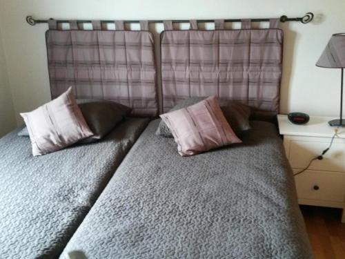 un lit avec deux oreillers dessus dans une chambre dans l'établissement Maison Confortable Barbâtre 4/6 Pers - Proche Plage et Commerces - WiFi Gratuit - FR-1-823-91, à Barbâtre