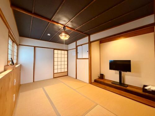 a room with a flat screen tv and a flat screen tv at Miyazakiya Kitayama - Hanare - in Kyoto