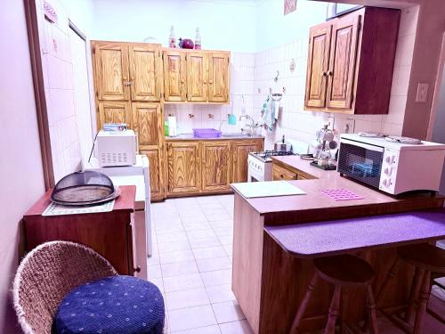 a kitchen with wooden cabinets and a counter top at El Roi apartment in Middelburg