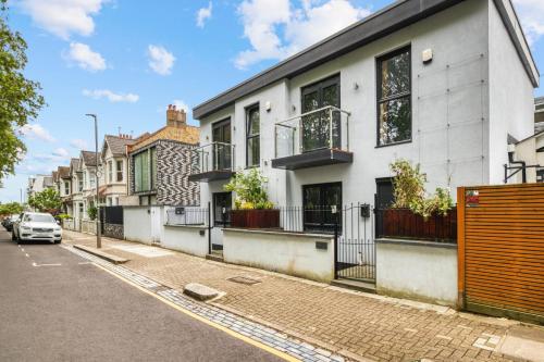 a row of houses on a street with a car at Unique Stylish Duplex 2BR 2BA Balcony in London