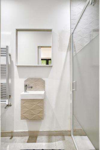 a white bathroom with a sink and a shower at Unique Stylish Duplex 2BR 2BA Balcony in London