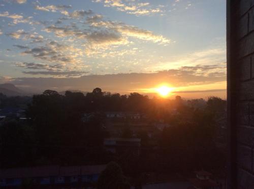 a sunset view from a window of a city at Hotel Utsab Himalaya in Pokhara