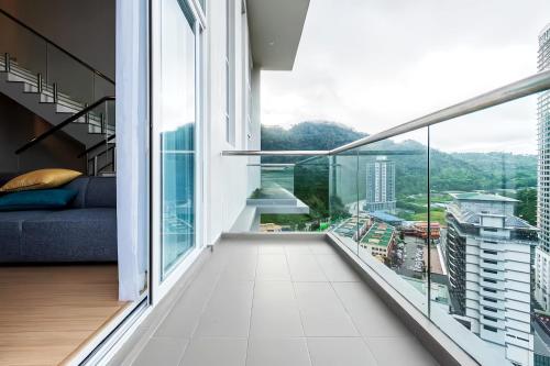 an apartment balcony with a view of the city at Windmill Upon Hills Genting Highland in Genting Highlands