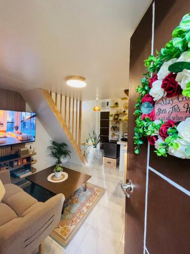 Una sala de estar con un sofá y una mesa y una puerta. en Binangonan Primes Tiny Home with FREE breakfast, en Binangonan
