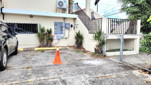 an orange cone sitting in front of a house at Jayuya Cozy Aparment with Wi-Fi, Free Parking and AC in Jayuya