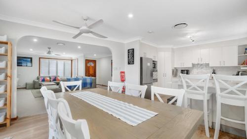 a kitchen and dining room with a table and chairs at Umina Beach Coastal Getaway in Umina Beach 