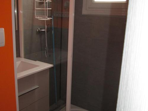 une douche avec une porte vitrée à côté d'un lavabo dans l'établissement Maison Noirmoutier 6 pers proche plage, animaux OK - FR-1-823-107, à Barbâtre