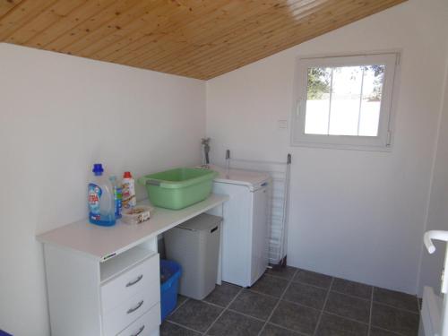 une petite cuisine avec un évier et une fenêtre dans l'établissement Maison confortable à Noirmoutier pour 6 pers., proche plage - FR-1-823-104, à Noirmoutier-en-l'lle