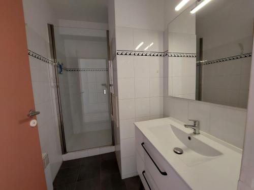 une salle de bain blanche avec un lavabo et une douche dans l'établissement Charmant T2 avec piscine à 2 min de la plage - FR-1-239-1104, à Urrugne