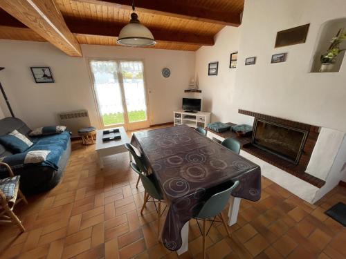 un salon avec une table et un canapé dans l'établissement Maison calme Noirmoutier Plage Sableaux, Animaux admis - FR-1-823-134, à Noirmoutier-en-l'lle
