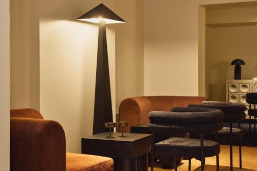 a barber shop with a group of stools in a room at Hotel Diplomat Sydney in Sydney