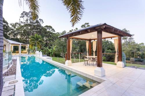 a pool with a gazebo next to a house at Alaya Verde Bed & Breakfast in Ringtail Creek