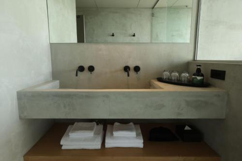 a bathroom with a large sink and a mirror at KITOW private villa in Awaji