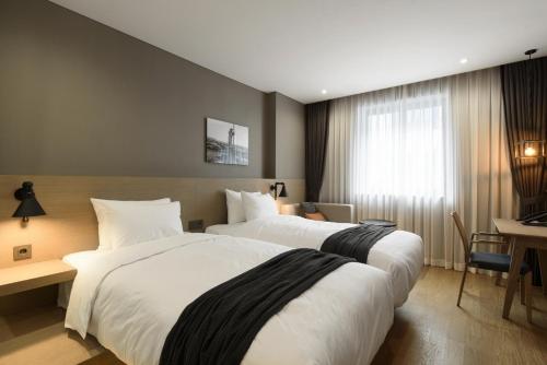 Ein Bett oder Betten in einem Zimmer der Unterkunft Hotel28 Myeongdong