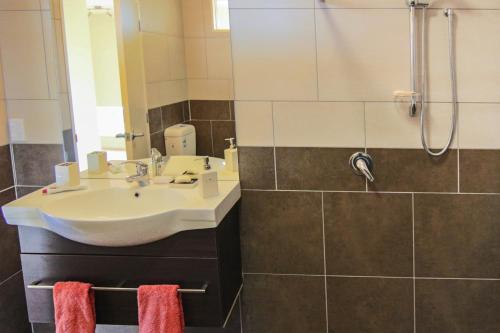 a bathroom with a sink and a shower at AislingQuoy in Amberley