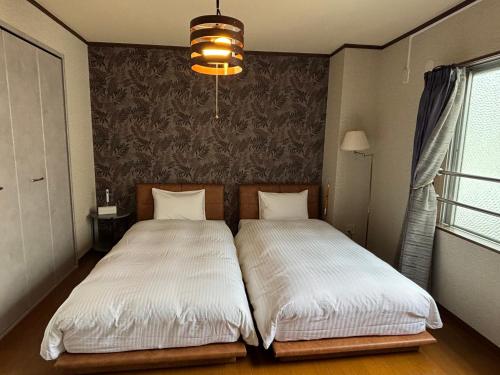 Una cama o camas en una habitación de SakuraPiso