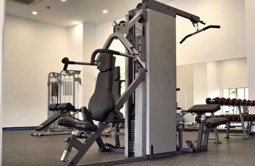 a gym with several tread machines in a room at Silverscape Seaview Residence Melaka in Melaka