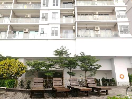 a row of benches in front of a building at Silverscape Seaview Residence Melaka in Melaka