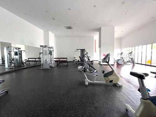 a gym with several treadmills and exercise bikes at Silverscape Seaview Residence Melaka in Melaka